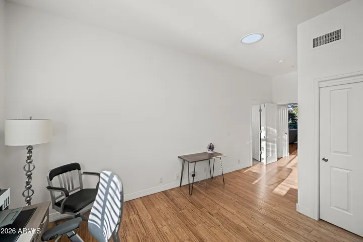 Scottsdale flex space ideal for a home office or workout room. Bright interior with wood flooring and natural light, perfect for modern living needs.