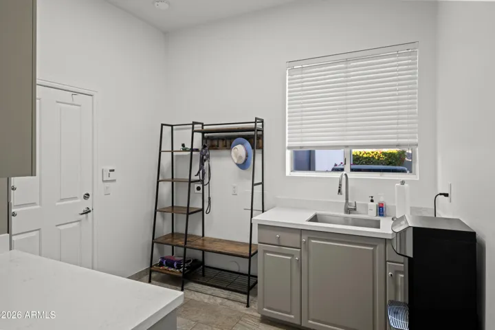Scottsdale mudroom with direct garage access, featuring storage shelving and functional layout. Perfect for organization and everyday convenience.
