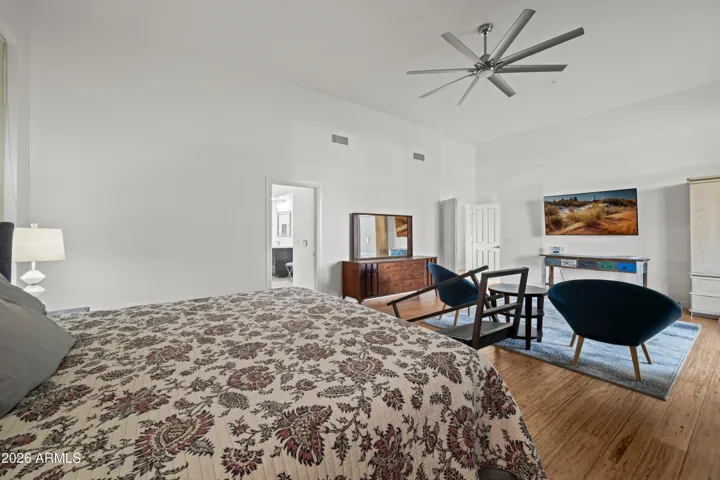 Scottsdale primary bedroom with direct access to the back patio, large windows, and natural light. Seamless indoor-outdoor living enhances comfort and lifestyle.