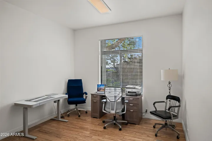 Scottsdale bedroom located near the primary suite, offering flexibility for guests or family. Features wood flooring, natural light, and versatile layout.