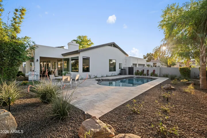 Scottsdale backyard featuring a private play pool, paver patio, and low-maintenance desert landscaping. Designed for outdoor relaxation and entertaining.