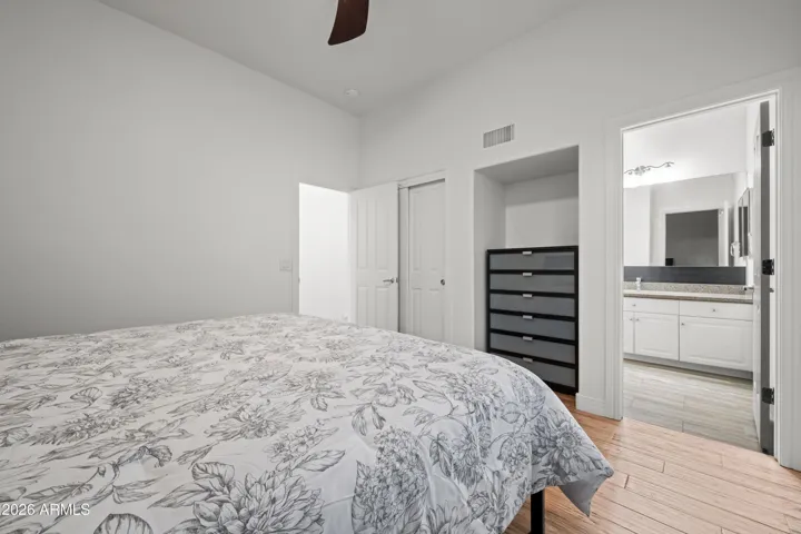 Scottsdale bedroom with spacious 12x12 layout, wood flooring, and bright interior. Ideal for guests, family, or flexible living arrangements.