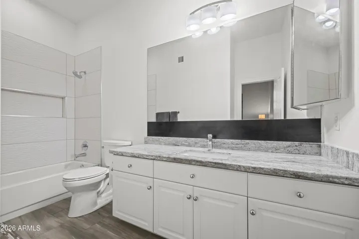 Scottsdale ensuite bathroom with full tub, extended vanity, and updated finishes. Bright, clean design offers both functionality and comfort.