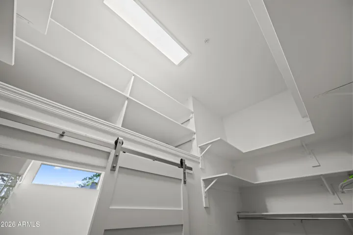 Scottsdale home featuring additional storage space with built-in shelving and overhead organization. Bright and functional design enhances everyday living and efficiency.