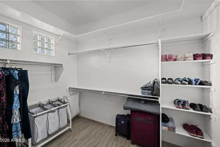 Scottsdale primary suite closet with ample shelving, hanging space, and organization. Designed for efficient storage and easy access.