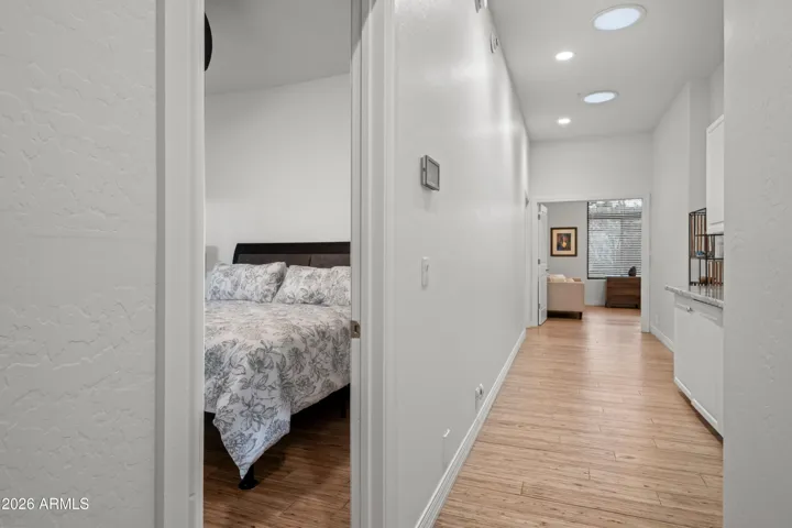 Scottsdale hallway enhanced with solar tubes for natural lighting. Wide layout with wood flooring creates a bright and open feel throughout the home.