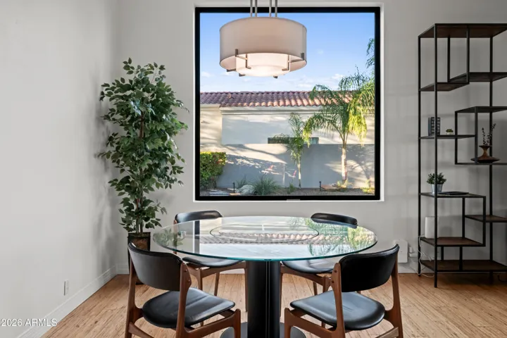 Cozy Scottsdale dining nook with large picture window, modern lighting, and stylish finishes. Bright space perfect for casual dining with outdoor views.