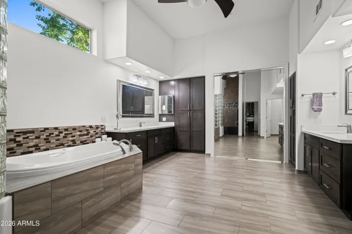 Expansive Scottsdale primary bathroom with modern finishes, tile flooring, and open layout. Designed for relaxation with updated features and ample space.