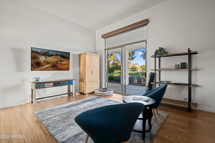 Bright Scottsdale bedroom space with sliding glass doors leading to the patio. Enjoy outdoor views, natural light, and easy access to the landscaped yard.