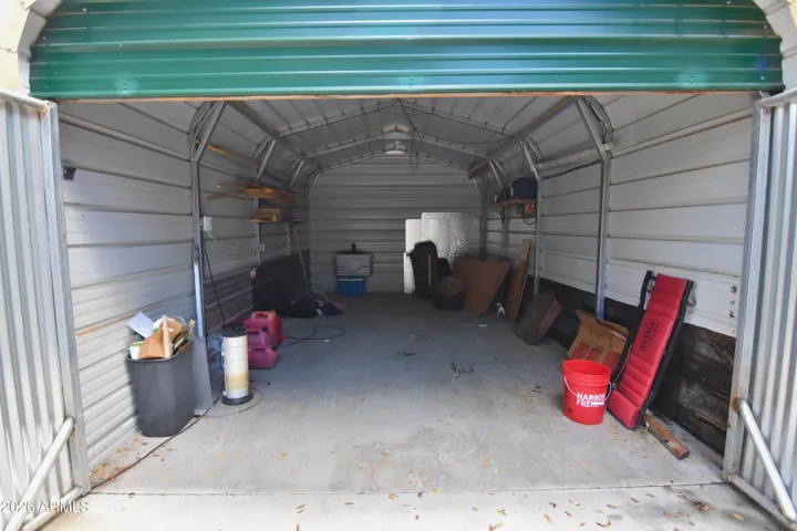 Enclosed Carport to house another vehicle. Would be a great workshop, she-shed, or just extra storage.