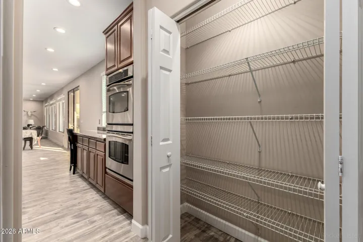 Spacious pantry with ample shelving and easy kitchen access.
