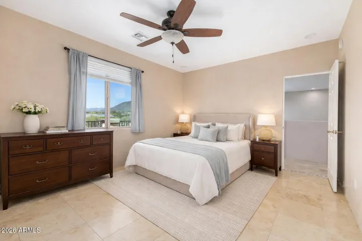Bright and airy bedroom featuring large windows and scenic views.