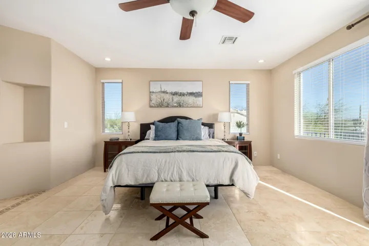 Bright and airy bedroom with large windows and abundant natural light.