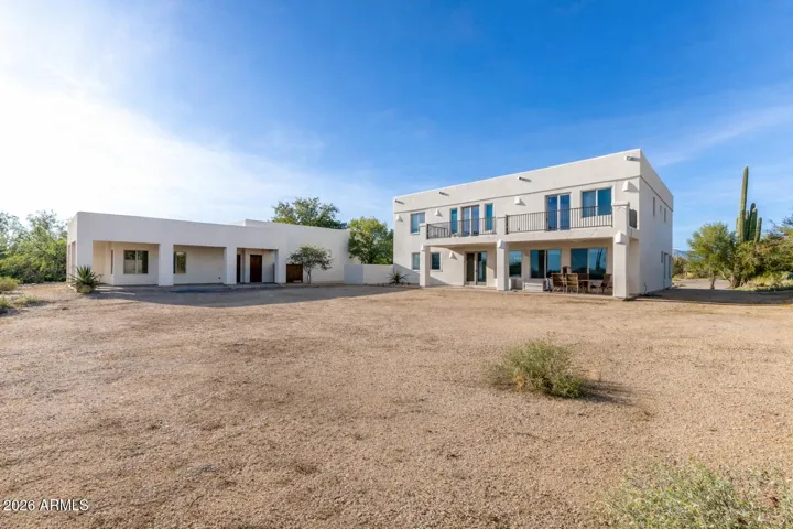 Beautiful view of the main home and guest house on a large lot with ample outdoor space.