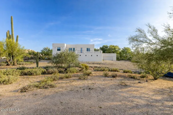 Private backyard setting with natural desert terrain and peaceful surroundings.