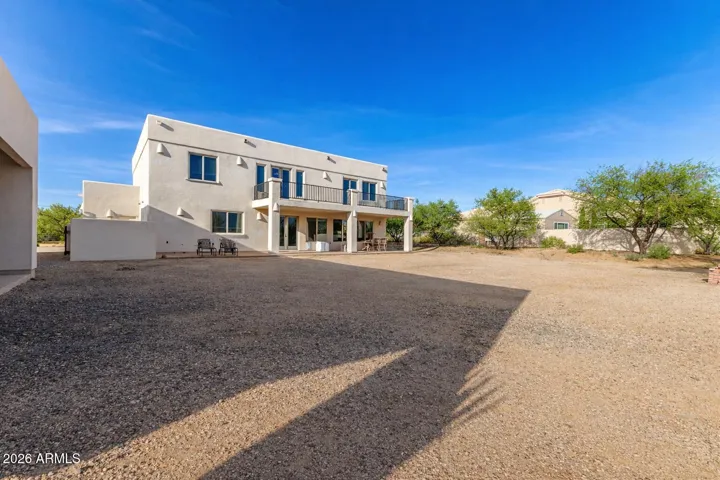 Wide-open backyard with endless potential and serene desert surroundings.
