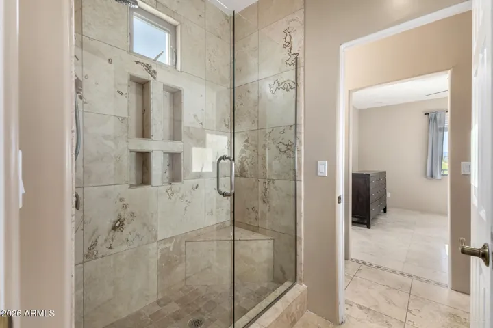 New Glass-enclosed shower with custom tilework and built-in niches.