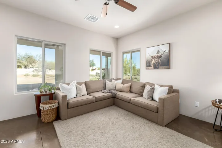 Light-filled living room with large windows and relaxing ambiance.