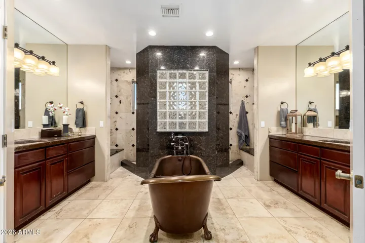 Elegant, symmetrical layout with dual vanities and a statement soaking tub.