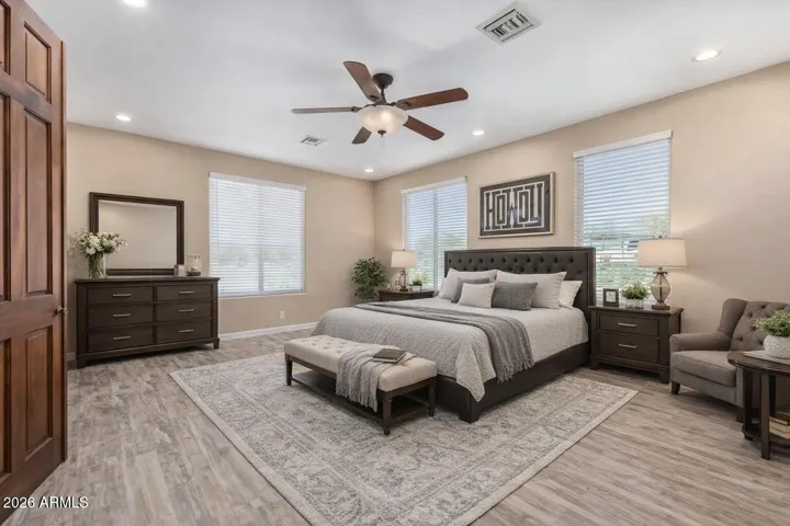 Thoughtfully staged as a serene primary retreat, this suite offers generous space, soft neutral tones, and a layout that blends functionality with everyday luxury.