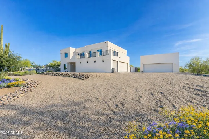 Modern desert residence with clean lines, expansive driveway and garage space.