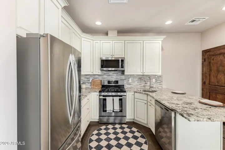 Efficient layout with breakfast bar seating and modern finishes.