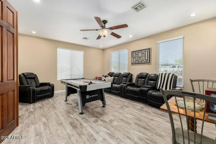 Open-concept bonus room with sleek flooring, modern ceiling fan, and flexible layout—ideal for a media room, play area, or additional lounge space.