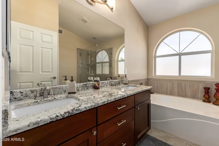 Main bathroom with separate tub and beautiful tiled shower
