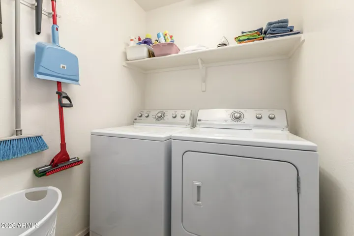 Laundry in hallway with room for storage