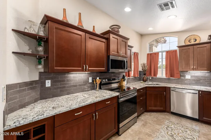 Beautiful wood kitchen cabinets with granite countertops and stainless appliances