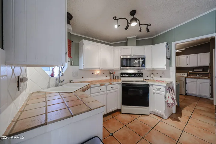 Kitchen with built in microwave. Opens to laundry room on right