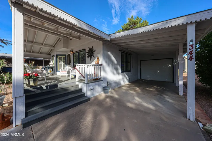 Single Garage on right with covered carport. Step to front deck