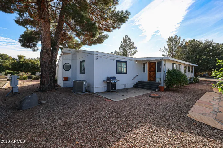 North side of home has Arizona room and patio for BBQ etc.