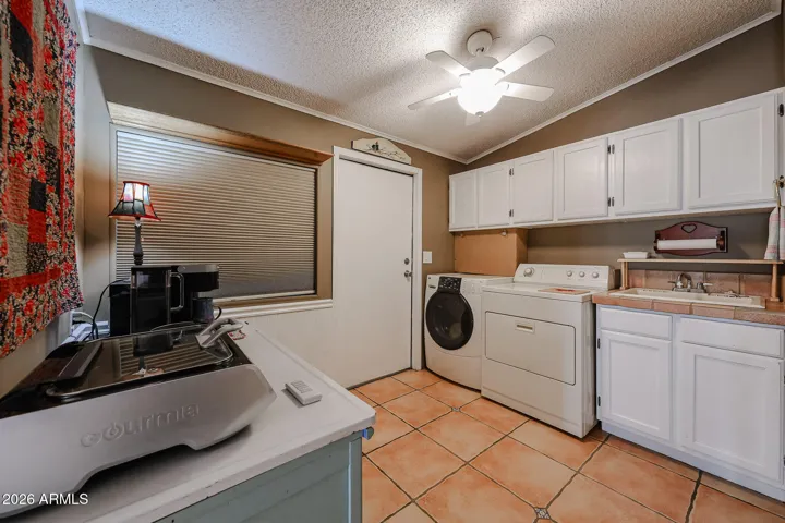 good sized laundry room with cabinets