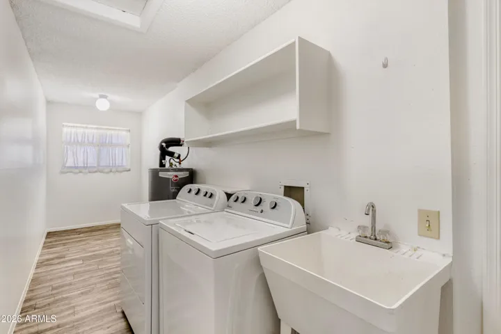 Larger indoor laundry space, room for desk by the window.
