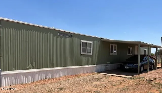 Back of home with carport
