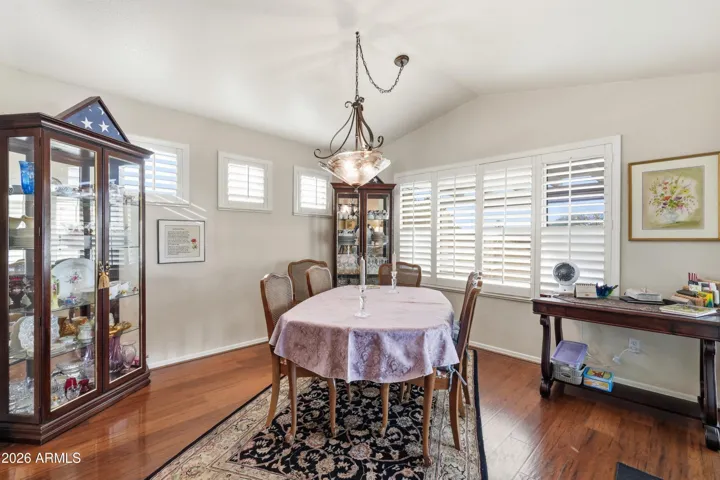 Expansive formal dining area open to extra 265 sq ft of air conditioned Arizona Room and pool.
