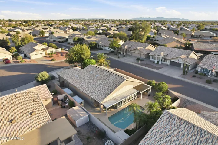 This large lot includes pebbletec pool and two custom storage units.