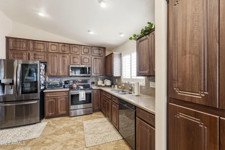 Large kitchen with stainless appliances.