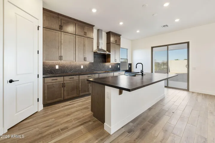 STACKED GOURMET KITCHEN CABINETS TO THE 10' CEILING, HONED GRANITE COUNTERS, DESIGNER BACKSPLASH, BUILTIN APPLIANCES ALONG WITH A BUILTIN DESK!