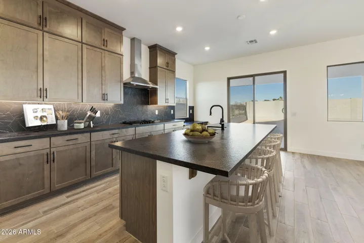 STACKED GOURMET KITCHEN CABINETS TO THE 10' CEILING, HONED GRANITE COUNTERS, DESIGNER BACKSPLASH, BUILTIN APPLIANCES ALONG WITH A BUILTIN DESK!