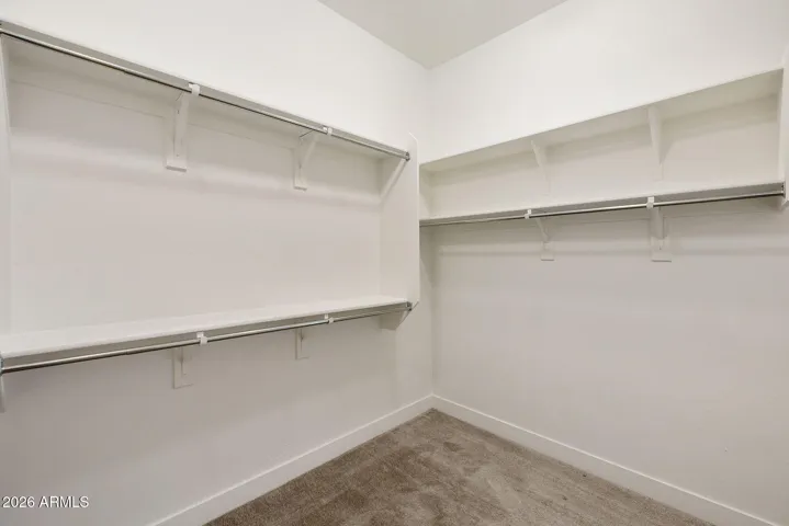 LARGE OWNERS BATH WITH DOUBLE VANITIES, WITH HONED GRANITE TOPS, TILED SHOWER AND LARGE WALK IN CLOSET