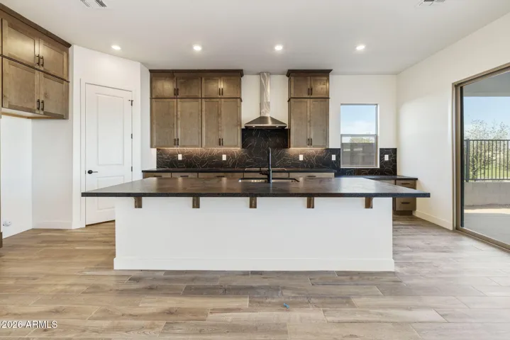 STACKED GOURMET KITCHEN CABINETS TO THE 10' CEILING, HONED GRANITE COUNTERS, DESIGNER BACKSPLASH, BUILTIN APPLIANCES ALONG WITH A BUILTIN DESK!