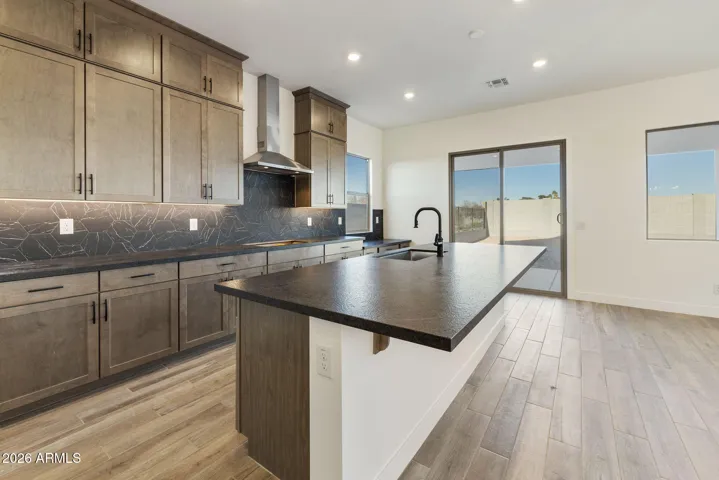 STACKED GOURMET KITCHEN CABINETS TO THE 10' CEILING, HONED GRANITE COUNTERS, DESIGNER BACKSPLASH, BUILTIN APPLIANCES ALONG WITH A BUILTIN DESK!