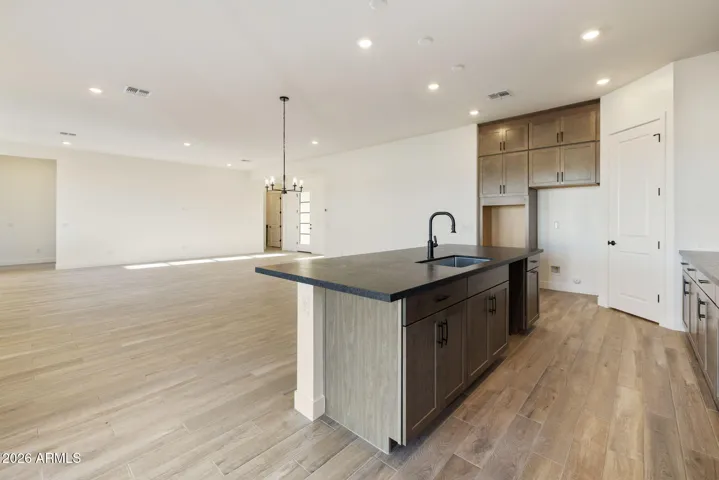 STACKED GOURMET KITCHEN CABINETS TO THE 10' CEILING, HONED GRANITE COUNTERS, DESIGNER BACKSPLASH, BUILTIN APPLIANCES ALONG WITH A BUILTIN DESK!