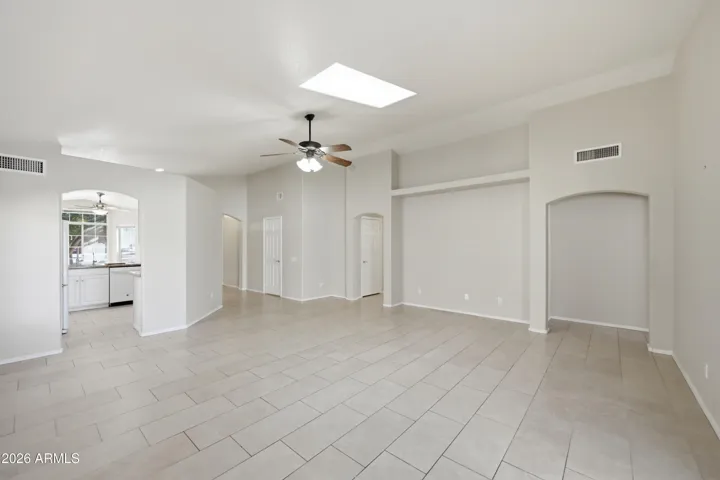 To the right of the entertainment niche is primary bedroom and to the left are the other 2 bedrooms.