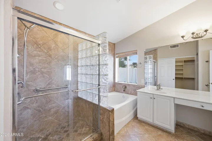 Spacious primary bathroom with separate shower and tub.