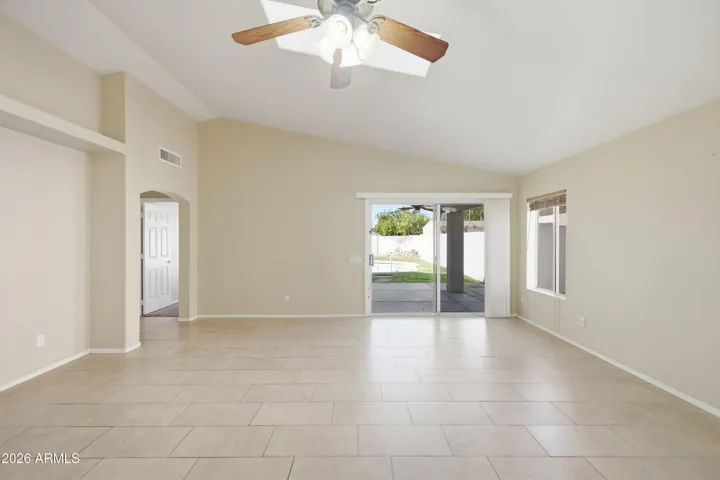 Large great room with vaulted ceilings and a custom sky light providing great natural light!