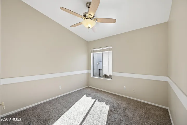 Chair rail decorates wall of this bedroom.