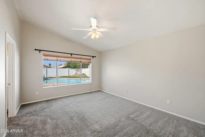Large primary bedroom overlooks the pool.